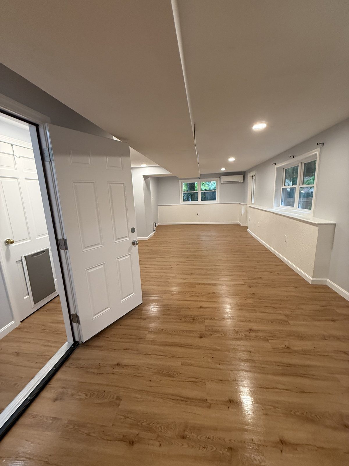 Finished basement in southern New Hampshire after a J&B Pro Cleaning post-construction clean: new vinyl plank floors, fresh paint and trim with all construction dust removed